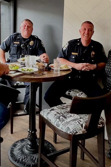 Police officers sitting at a table.